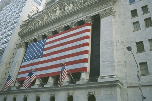 USA, New York, Manhattan, The Stock Exchange on Wall Street with columns draped with Stars and Strpes flag