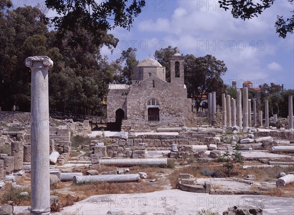 CYPRUS, Ayia Kyriaki, Twelth century Byzantine church.  Part restored exterior in area of fallen masonry and ruined remains of standing columns.