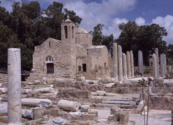 CYPRUS, Ayia Kyriaki, Twelth century Byzantine church.  Part restored exterior in area of fallen masonry and ruined remains of standing columns.
