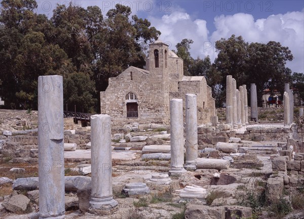 CYPRUS, Ayia Kyriaki, Twelth century Byzantine church.  Part restored exterior in area of fallen masonry and ruined remains of standing columns.