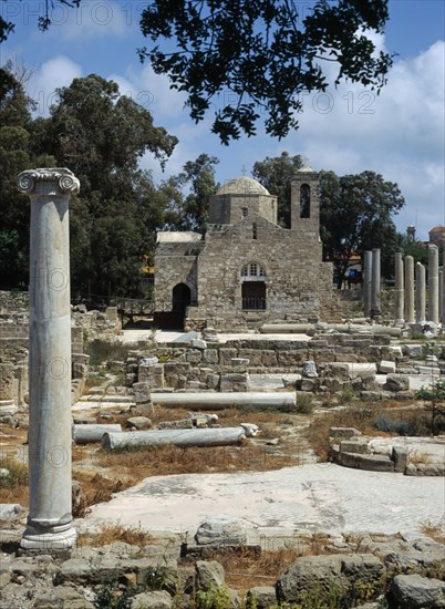 CYPRUS, Ayia Kyriaki, Twelth century Byzantine church.  Part restored exterior in area of fallen masonry and ruined remains of standing columns.