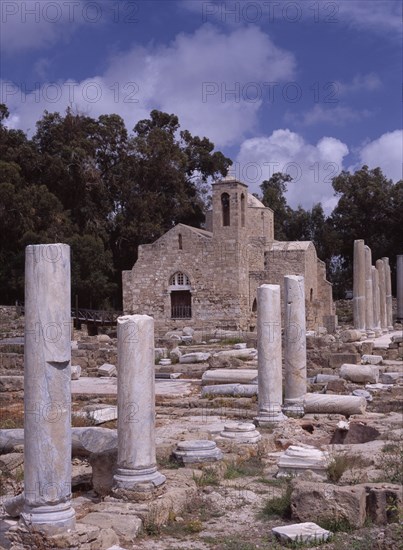 CYPRUS, Ayia Kyriaki, Twelth century Byzantine church. Part restored exterior in area of fallen masonry and ruined remains of standing columns.