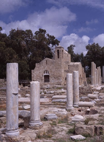 CYPRUS, Ayia Kyriaki, Twelth century Byzantine church.  Part restored exterior in area of fallen masonry and ruined remains of standing columns.