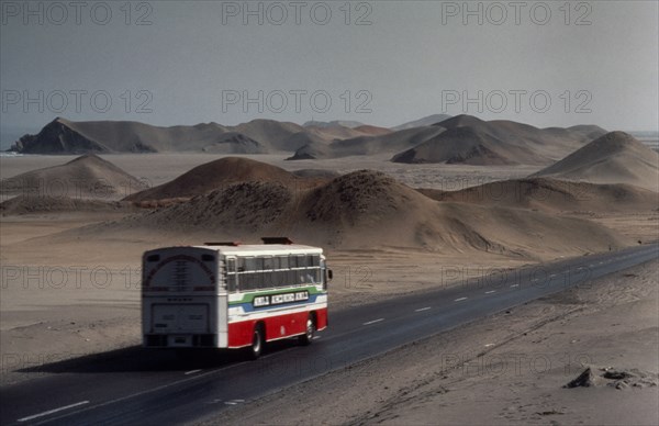 PERU, Landscape, Bus on the Pan American highway through coastal desert connecting Ecuador and Chile.