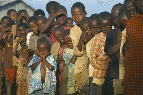 TANZANIA, Henu Oshinga, Hutu refugee children at Henu Oshinga camp waiting for distribution of clothing.