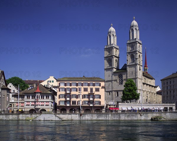 SWITZERLAND, Zurich Canton, Zurich, View across the River Limmat towards Grossmunster twin towered church and waterside buildings.