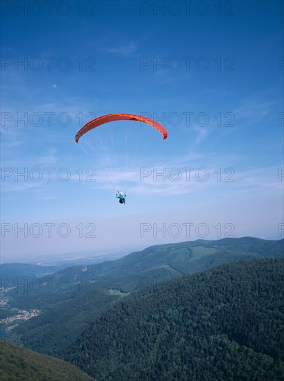 FRANCE, Alsace, Haut Rhin, Paraglider decending from Ballon de l Alsace