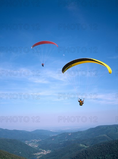 FRANCE, Alsace, Haut Rhin, Paragliders decending from Ballon de l Alsace