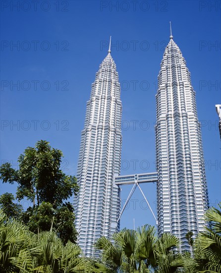 MALAYSIA, Kuala Lumpur, Petronas Twin Towers. Angled view looking up at the multi storey buildings housing corporate headquarters