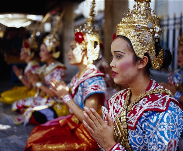 THAILAND, Bangkok, Erawan Shrine. Dancers performing for devotees who give thanks for good luck received