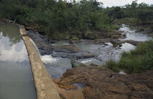 KENYA, Kipsaraman, Dam built by local woman Pauline Rerimoi.  Previously she had had to carry a twenty litre container of water along cliff paths in a four hour trip.