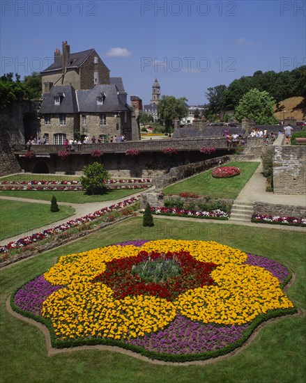 FRANCE, Brittany Morbihan, Vannes, Hermine Castle walls and formal gardens with colourful flowerbed in the foreground.