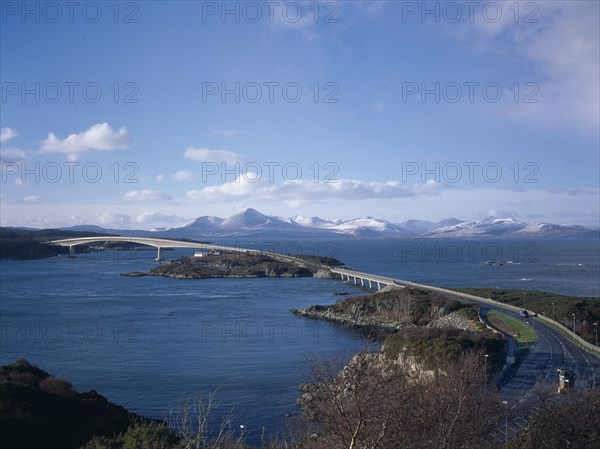 SCOTLAND, Highlands, Isle of Skye, View over the 1.5 mile long Toll Bridge spanning Loch Alsh from the Kyle of Lochalsh on the mainland to Kyleakin on Skye and the Cuillin Hills in the distance