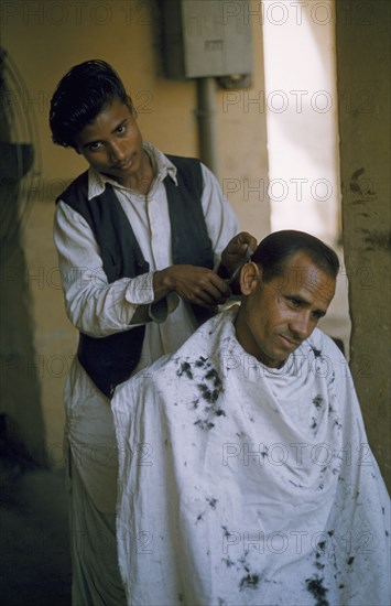 INDIA, Personal Grooming, Young barber and customer.