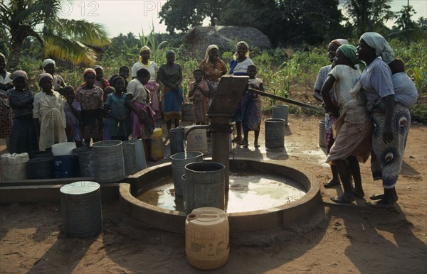 MOZAMBIQUE, Inhambane Province, Water, Village women and children using UNICEF water well.  Water is pumped by hand.
