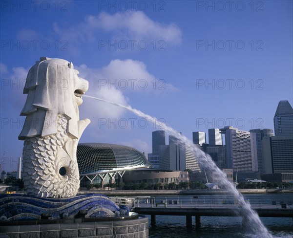 SINAGAPORE, General, Merlion statue spouting water in to the Singapore River with the city skyline beyond