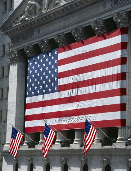 USA, New York, Manhattan, Wall Street stock exchange with stars and stripes flag draped across the colonnaded facade