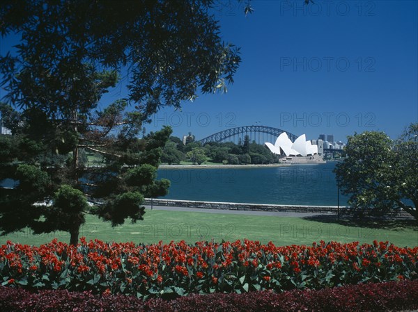 AUSTRALIA, New South Wales, Sydney, View of the Sydney Opera House and Harbour Bridge seen from the Royal Botanic Gardens