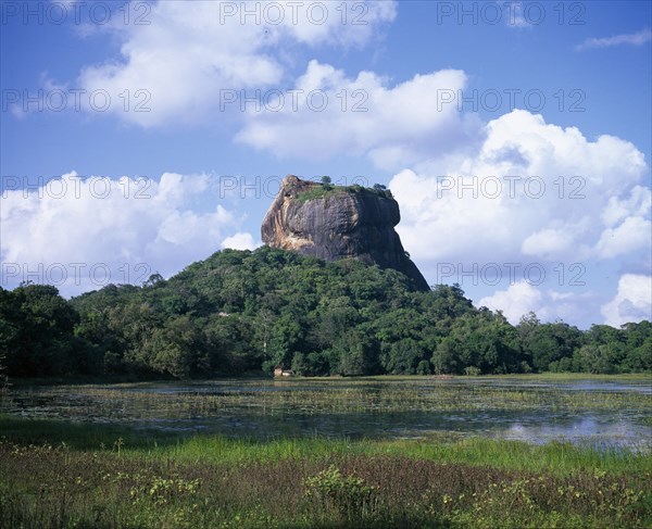 SRI LANKA, Sigiriya, View over lily pond toward the Lion Rock monolith