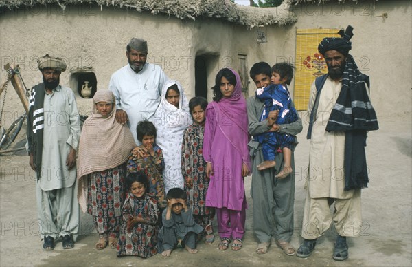 PAKISTAN, Family, Family portrait of Baluchi men and children.  Modesty prevents the wives from being photographed.  Muslim women tend to take a background role.