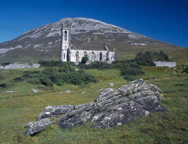 IRELAND, Donegal, Mount Errigal, Ruined church in The Poisened Glen with Errigal peak of the Derryveagh Mountain Range behind