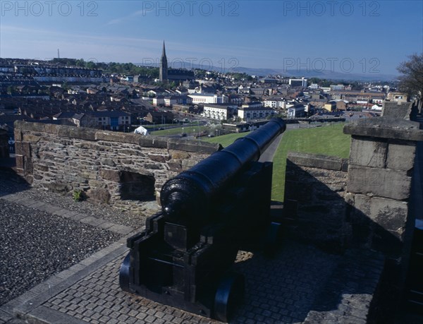 IRELAND, North, Derry, General view over the city from the city walls toward the Bogside with cannon in the foreground
