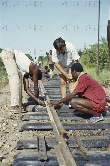 ZAMBIA, Transport, Construction workers under supervision on Canadian run railway.