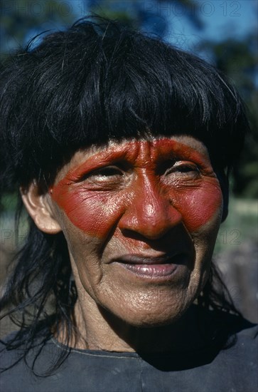 ECUADOR, Amazon, People, Portrait of Auca Indian with red face paint from achole plant.