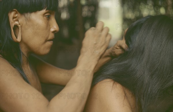 ECUADOR, Amazon, Auca Indians grooming.