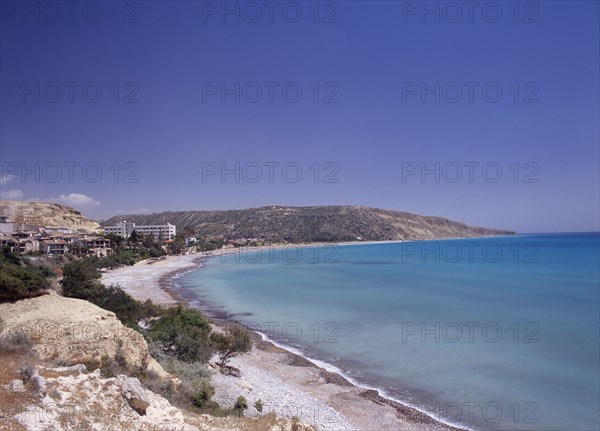 CYPRUS, Pissouri, "Quiet half moon beach and Pissouri Bay with surrounding rocky coastline, hotel and other buildings. "