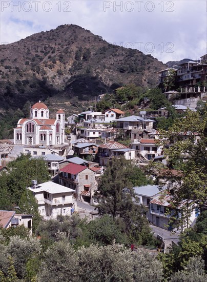 CYPRUS, Troodos Mountains, Moutoullas, Church and village houses on hillside.