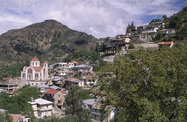 CYPRUS, Troodos Mountains, Moutoullas, Church and houses on steep hillside.