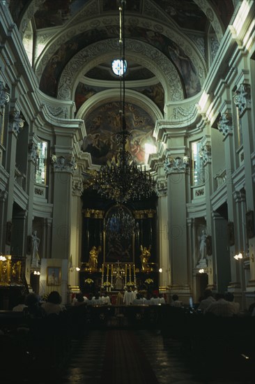 POLAND, Krakow, "Church interior with painted vaulted ceiling, choir and congregation. "