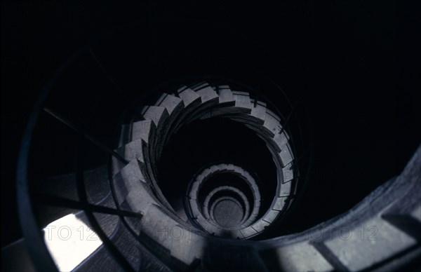 ITALY, Marche, Urbino, Ducal Palace. Angled view looking down a spiral staircase