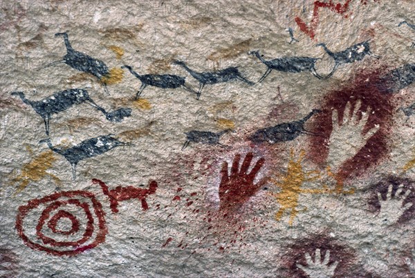 ARGENTINA, Patagonia, Cueva de las Manos, "Cave of the Hands.  Prehistoric rock paintings of human hands and animals in red black and orange 13,000 to 9,500 years old."
