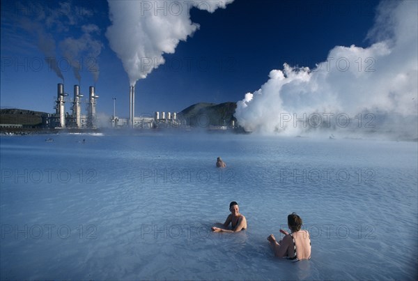 ICELAND, Svartsengi, The Blue lagoon Geothermal power plant with people bathing in the theraputic water.