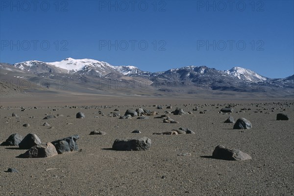 BOLIVIA, Altiplano, Potosi, Salar de Uyuni.  Desert landscape scattered with rocks near Laguna Verde.