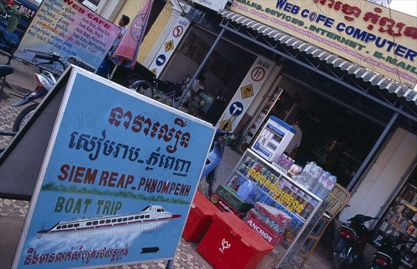 CAMBODIA, Siem Reap, Boat trip sign on the pavement outside an Internet cafe