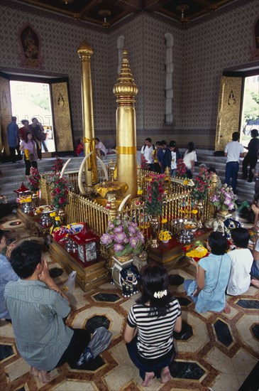 THAILAND, South, Bangkok, Wat Meuang the City pillar the most important animist shrine in Bangkok with devotees making offerings