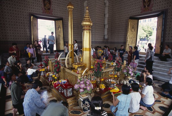 THAILAND, South, Bangkok, Wat Meuang the City pillar the most important animist shrine in Bangkok with devotees making offerings