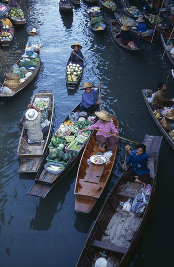 THAILAND, South, Bangkok, Damnoen Saduak Floating Market fruit vendors in their canoes on the main canal