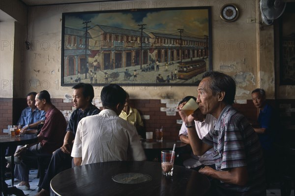 THAILAND, South, Bangkok, Chinatown teahouse with male locals seated in front of an old painting of Chinatown