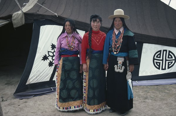 CHINA, Quinghai Province, Tibetan mother and daughters dressed in their traditional best clothes.