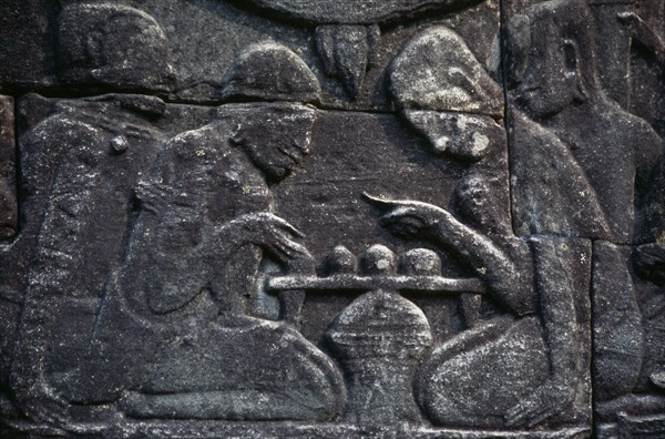 CAMBODIA, Siem Reap Province, Angkor Thom, Bayon.  Bas relief carvings on the south wall depicting everyday scenes.  Chess players.