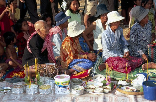 CAMBODIA, Siem Reap, Angkor Wat, Shaman ceremony Khmer people with offerings of food in front of them on the ground