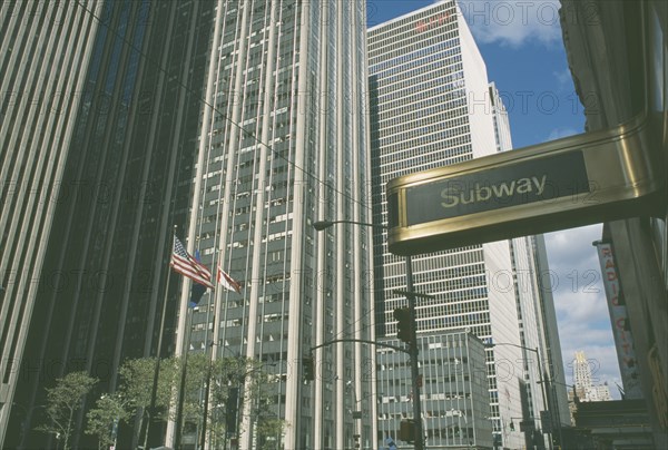 USA, New York, Manhattan, Art deco subway sign on 6th avenue with the Time Life building behind