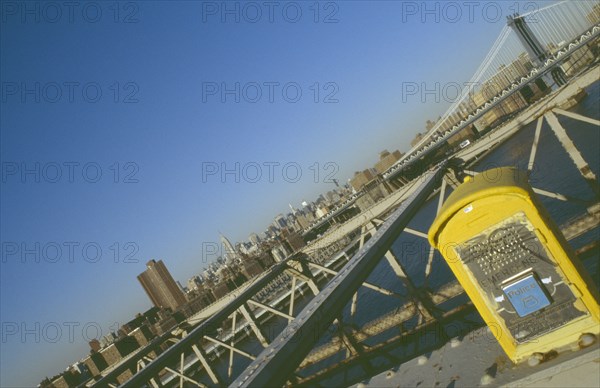 USA, New York, Manhattan, Manhattan and the Empire State building viewed from the walkway on the Brooklyn Bridge