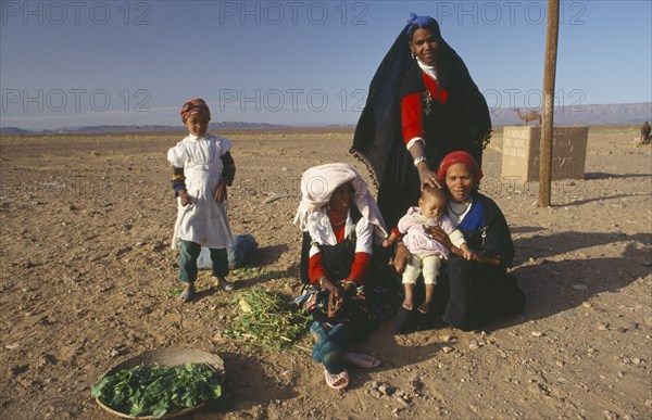 MOROCCO, Family, Tribal woman and children in desert area.