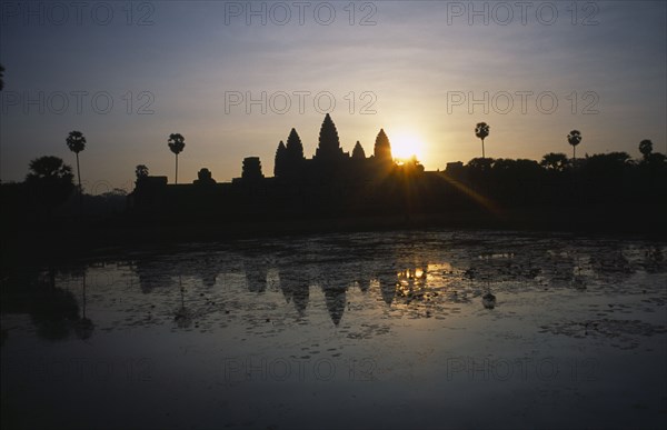 CAMBODIA, Siem Reap, Angkor Wat, The central complex seen across the water lilly pond at sunrise