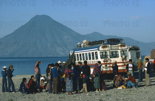 MEXICO, Transport, A group of passengers gathered around a bus with mountain scenery behind.